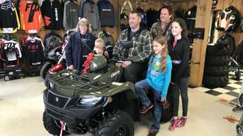 Daley on his new ATV surrounded by his family at Bob's Motor Sports in Chatham, May 12, 2018. (Photo courtesy of Chatham-Kent ATV Club Twitter)
