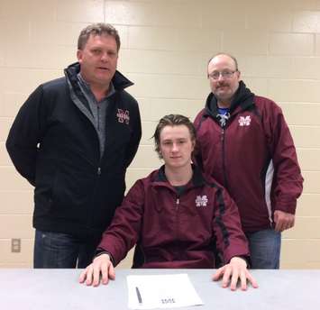 Grant Spence signs with  the Chatham Maroons.  (Photo courtesy of the Chatham Maroons)