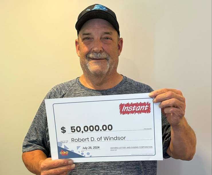 Robert Dikan of Windsor shows off his $50,000 prize cheque at the OLG Prize Centre in Toronto, July 26, 2024. Photo provided by Ontario Lottery and Gaming.