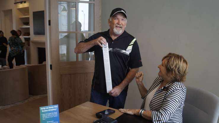 A resident purchasing a dream home ticket at the home in Plympton-Wyoming (Photo by: Lindsay Newman/ Blackburn Media)