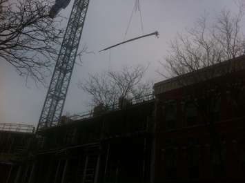 Workers unload a shipment of rebar at the downtown Chatham condo project site on January 23, 2015. (Photo by Mike James)