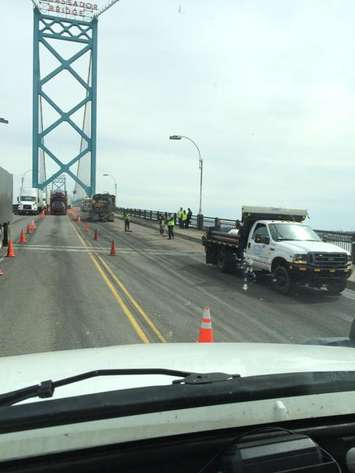 Crews work to clear debris on the Ambassador Bridge after a vehicle caught fire, April 14, 2015. (Photo courtesy Mike Parker/Twitter)