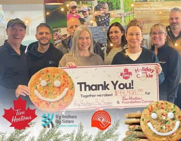 Staff at BBBS celebrate a donation from the Tim Hortons Holiday Smile Cookie Campaign (Photo via BBBS Facebook)