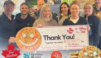 Staff at BBBS celebrate a donation from the Tim Hortons Holiday Smile Cookie Campaign (Photo via BBBS Facebook)