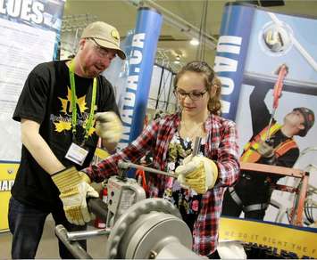Ontario student works on a pipe threading machine with a representative from the United Association of Journeymen and Apprentices. (Janis Reese/Kaleidoscope Photography)