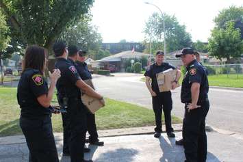 Chatham-Kent firefighters with carbon monoxide alarms in hand to give to those who don't have one, as part of the post fire reassurance initiative. September 6, 2016. (Photo by Natalia Vega)