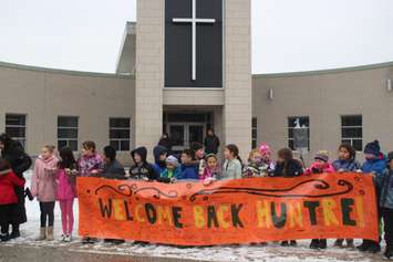 Students at Our Lady of Perpetual Help Elementary School in Windsor hold up a welcome banner for Huntre Allard on February 11, 2019. Photo by Mark Brown/Blackburn News.
