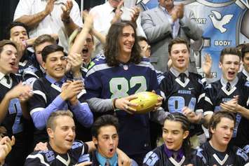 Seattle Seahawks Tight End Luke Willson presents St. Thomas of Villanova High School with a golden football, on behalf of the NFL, November 6, 2015. (Photo by Mike Vlasveld)