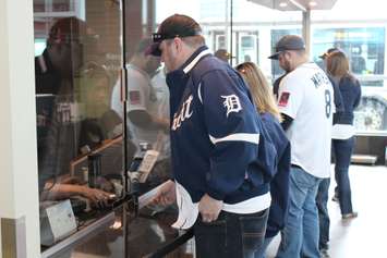 Detroit Tigers baseball fans buy tickets for the Transit Windsor Tunnel Bus on Opening Day 2015, April 6, 2015. (Photo by Mike Vlasveld)