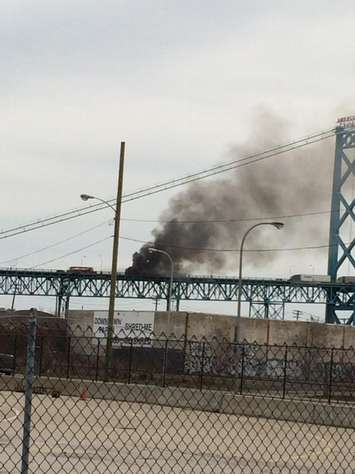 A vehicle catches fire on the Ambassador Bridge, April 14, 2015. (Photo courtesy Mike Parker/Twitter)