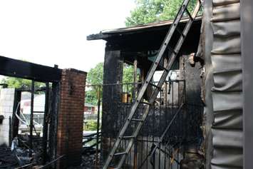 Fire destroyed a garage and damaged the rear of a home on Camelot Cres. July 7, 2015 (BlackburnNews.com photo by Dave Dentinger)