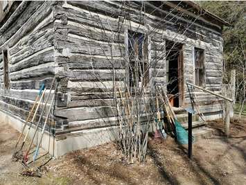 A log cabin and rakes at Longwoods Road Conservation Area. Photo courtesy of Lower Thames Valley Conservation Authority.