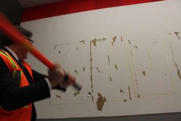 HGS Canada President Ross Beattie takes a sledge hammer to a wall at the former Zeller's at Tecumseh Mall, January 13 2015.  (Photo by Adelle Loiselle.)