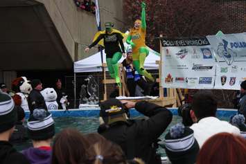 Two costumed St. Clair College students jump into a pool during the 2nd Annual Polar Plunge for Special Olympics Ontario at the College's main campus in Windsor, February 4, 2016 (Photo by Mark Brown)