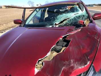 Police have charged a truck driver after a pole fell off a vehicle and struck a car travelling behind it. (Photo courtesy of the OPP)