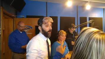 Matt Sampiao, morning host for K 106.3, gets ready to test his impaired driving skills on the virtual car simulator. Dec. 13, 2017. (Photo by Colin Gowdy)