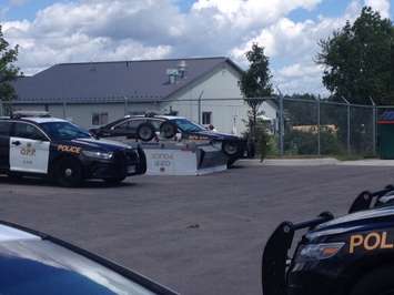 OPP trailer thrown 60 metres by Teviotdale tornado and lands between two cruisers (Photo by Steve Sabourin)
