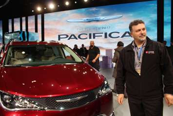 Unifor President Dino Chiodo poses with he Chrysler Pacifica unveiled at the North American International Auto Show 2016. (Photo by Maureen Revait) 