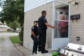 Chatham-Kent firefighters going door-to-door on Timmins Cres., during their post fire reassurance initiative. September 6, 2016. (Photo by Natalia Vega)