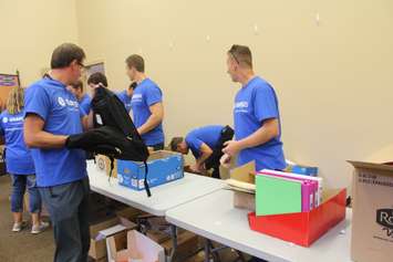 Volunteers filling backpacks with school supplies for local children going back to school. August 29, 2016. (Photo by Natalia Vega)