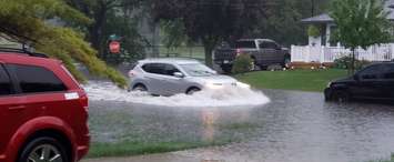A vehicle tries to drive down a flooded street. (File photo submitted to BlackburnNews.com) 