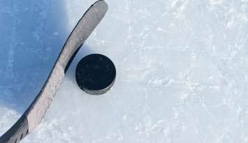 Hockey stick and a puck. © Can Stock Photo / bradcalkins
