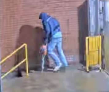 A person is seen outside the Canada Post in Tecumseh, April 5, 2022. Image provided by Ontario Provincial Police.