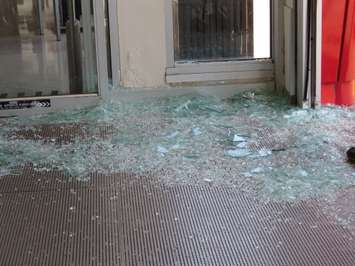 Glass covers the floor of the front entrance of the Shoppers Drug Mart at 645 Commissioners Rd. E after a car crashed through the doors, June 12, 2018. (Photo by Miranda Chant, Blackburn News)