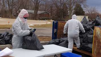 Staff inspect garbage during CKHA's annual waste audit on March 17, 2015. (Photo by Jake KIslinsky)