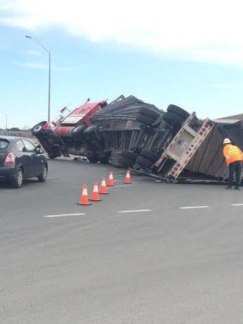 A tractor trailer flips over at the roundabout at Hwy. 3 and Hwy. 401, April 14, 2015. (Photo courtesy of Steve Dilauto)