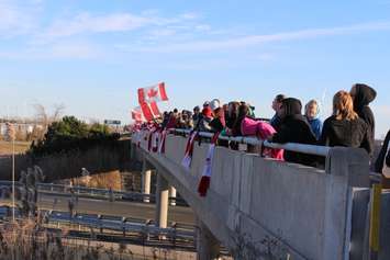Supporters come out to the Communications Rd. overpass on Hwy. 401 for the repatriation ceremony of fallen veteran and Wheatley native John Gallagher on November 20, 2015. (Photo by Ricardo Veneza)