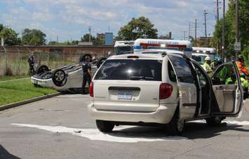 EMS crews tend to a number of people after a crash between a car and minivan at St. Luke Rd. and Richmond St., July 31, 2015. (Photo by Mike Vlasveld)