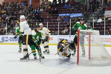 Sarnia Sting goaltender Ben Gaudreau dives for the puck in a game versus the London Knights.  16 November 2021.  (Metcalfe Photography)
