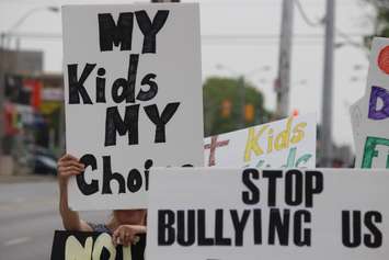 Parents and students hold a sex-ed protest outside NDP Windsor-West MPP Lisa Gretzky's office, June 5, 2015. (Photo by Jason Viau)