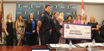 Charity Chix and Windsor police service present checks to charities, June 22, 2017. (Photo by Maureen Revait) 