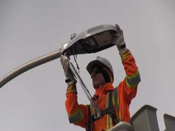Chris Carr with Enersource Power Services installs an LED street light outside of St. Rose Catholic Elementary School in Windsor on December 9, 2015. (Photo courtesy City of Windsor)
