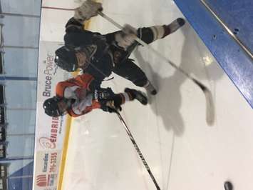 A Drayton player tries to get the puck from a Blyth-Brussels player. (Photo by Marty Thompson)