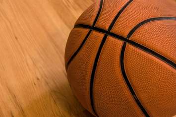 Basketball on a wooden floor close up. © Can Stock Photo / johnnychaos