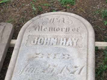A Confederation-era tombstone uncovered by Western students at Woodland Cemetery. (Photo by Miranda Chant, Blackburn News)