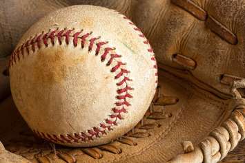 Softball in glove. © Can Stock Photo Inc. / Anke