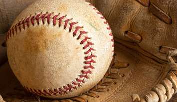 Softball in glove. © Can Stock Photo Inc. / Anke