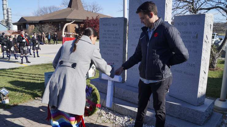 Chief Janelle Nahmabin putting a poppy on the cross during the Aamjiwnaang First Nation Remembrance Day ceremony, November 8, 2024 (Photo by: Lindsay Newman/ Blackburn Media) 