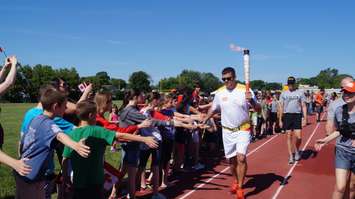 Torchbearer Joel Skinner finishes up the Sarnia Pan Am Games torch run June 16, 2015 (BlackburnNews.com Photo by Briana Carnegie)