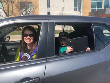 Ewan Spowart, a Grade 1 student at Sacred Heart Catholic School, Sarnia and his mom Wendy Fultz pick up a Board-issued Chromebook at St. Patrick’s Catholic High School. Photo courtesy of SCCDSB.