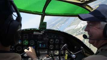Pilots Travis Major (right) and Richard Petty (left) flying over Sarnia in the B-25 