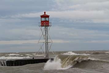 Waves wash by signal light at the Erieau channel Oct. 28, 2015 (Photo by Simon Crouch)