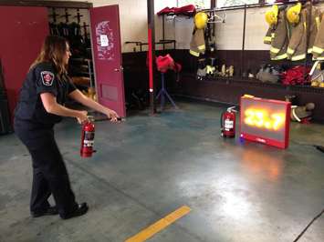 Whitney Burk public educator with the CK-Fire Department demonstrates and electronic extinguisher training tool September 9, 2015. (Photo by Simon Crouch) 