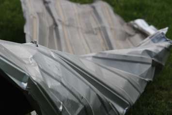 Metal siding strewn across the lawn near the EC Row Expressway and Central Avenue in Windsor on August 25, 2016. (Photo by Ricardo Veneza)