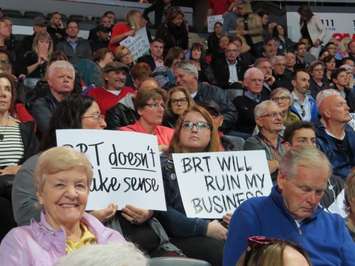 London residents hold up signs against the proposed BRT system at a public participation meeting at Budweiser Gardens, May 3, 2017. (Photo by Miranda Chant, Blackburn News)