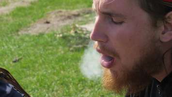 A man smokes a joint during 4/20 at London's Victoria Park, April 20, 2016. (Photo by Kirk Dickinson)